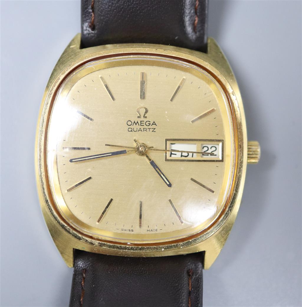 A gentlemans steel and gold plated Omega quartz day date wrist watch, on associated leather strap.